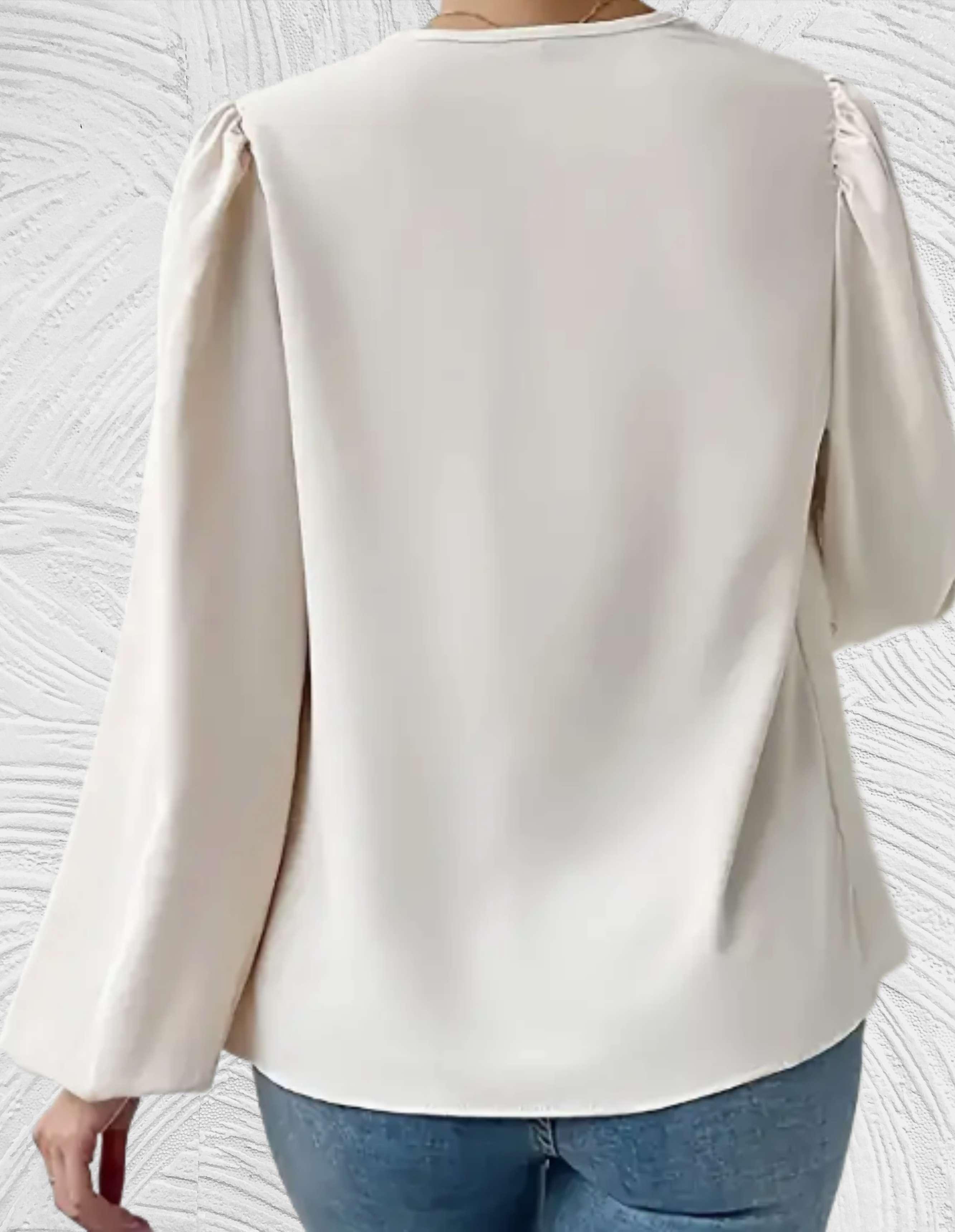 Witte top met lange pofmouwen en omslagmotieven